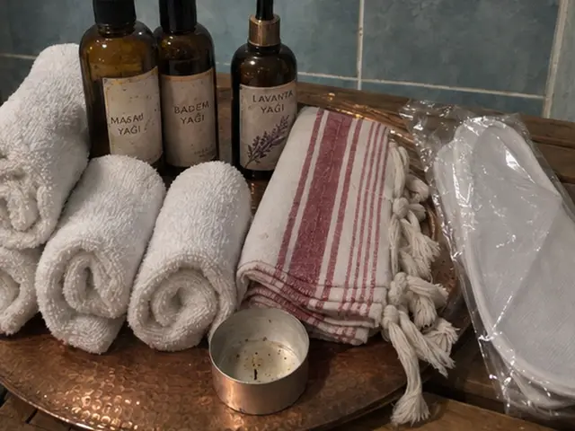 Bakır tepside rulo havlular, peştemal ve masaj yağları — Cevizlibağ, Masaj Salonun